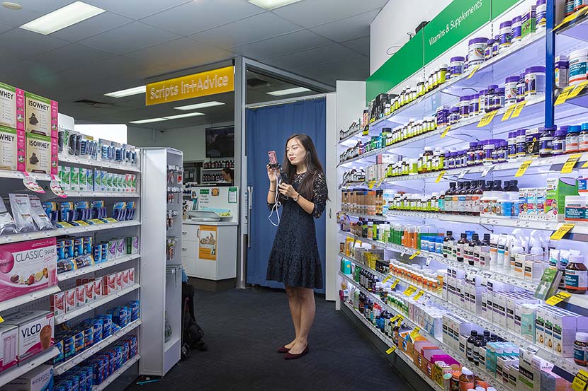 A woman livestreams while purchasing health products for her Chinese customers in Brisbane, Australia, April 18, 2018. VCG