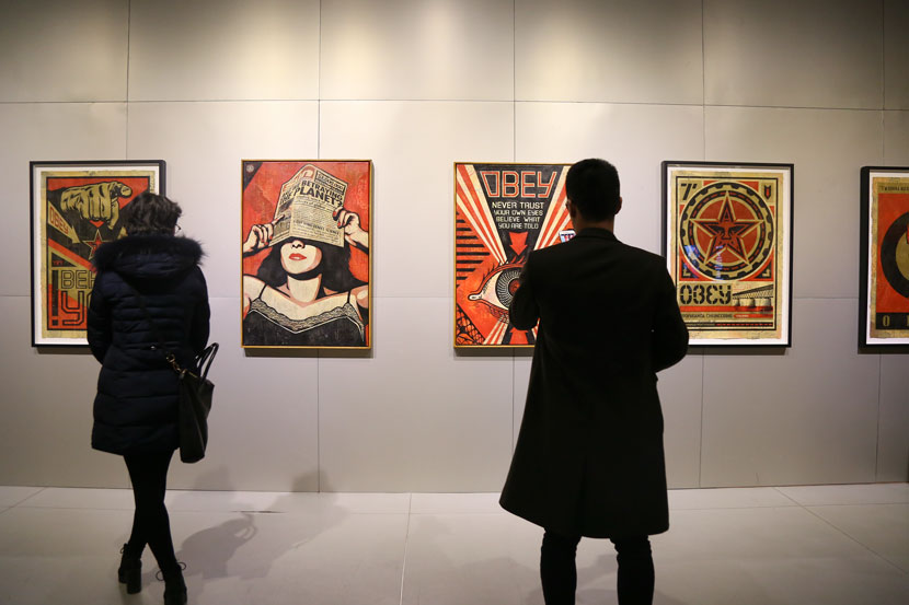Visitors take in works by Shepard Fairey at the “Post Contemporary-Urban Graphic 7019” exhibition in Shanghai, Jan. 24, 2019. Courtesy of MoCA Shanghai