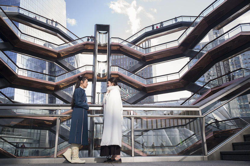 Two Chinese students in ancient “hanfu” clothing pose for a photo in front of the Vessel in New York, March 15, 2019. Liao Pan/CNS/VCG