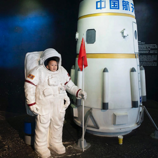 A boy poses for a photo at the Beijing Planetarium in Beijing, March 30, 2019. Matjaz Tancic for Sixth Tone