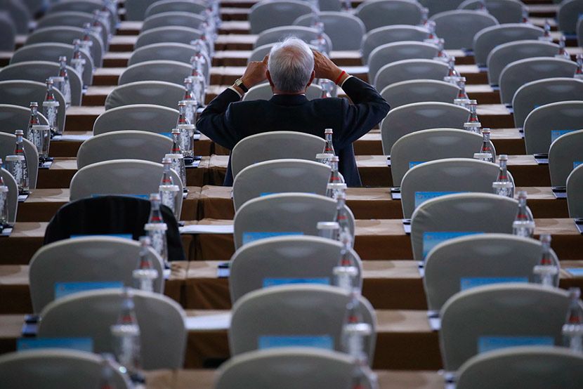 A participant of the second Belt and Road Forum for International Cooperation takes pictures from the seats before the opening ceremony in Beijing, April 26, 2019. How Hwee Young/EPA/IC