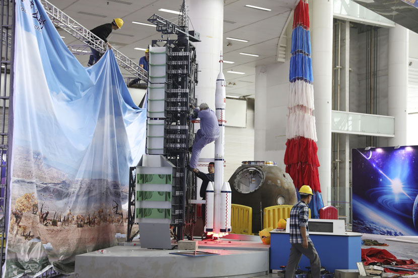Workers prepare a rocket model ahead of an exhibition to mark the fourth China Space Day in Changsha, Hunan province, April 22, 2019. Aly Song/Reuters/VCG