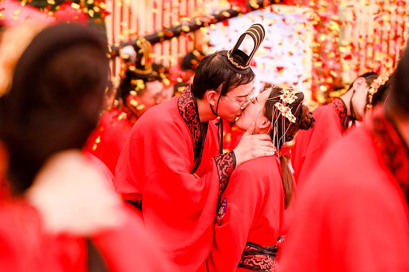 Two people kiss during a mass wedding ceremony at the headquarters of tech giant Alibaba in Hangzhou, Zhejiang province, May 10, 2019. The ceremony featured 102 couples, each with at least one person employed by Alibaba. VCG