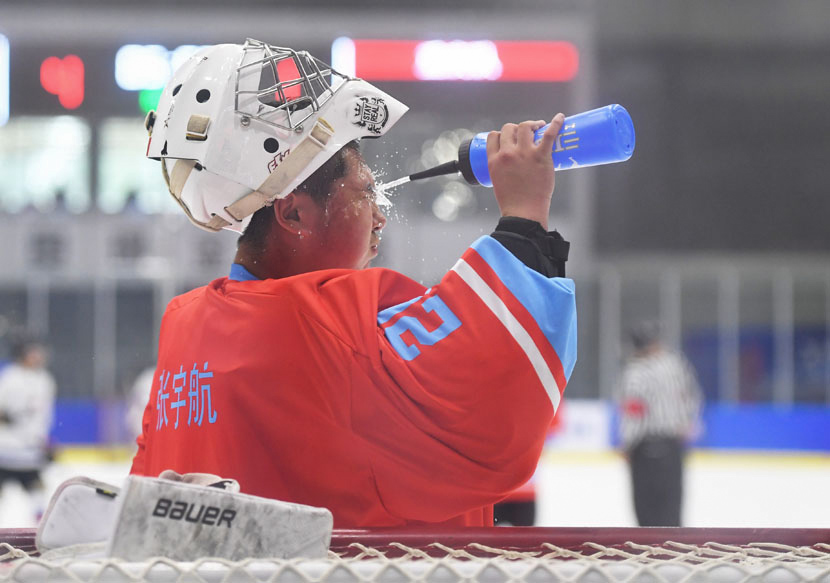 A hockey player sprays water on his face to cool off during a match in Beijing, June 5, 2019. Jia Yuchen/Xinhua