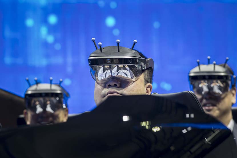 Visitors wearing virtual reality headsets try a driving system at a Nissan Motors Co. booth during the 2019 Consumer Electronics Show Asia in Shanghai, June 11, 2019. The tech event ran until June 13. Shen Qilai Shen/Bloomberg via Getty Images/VCG