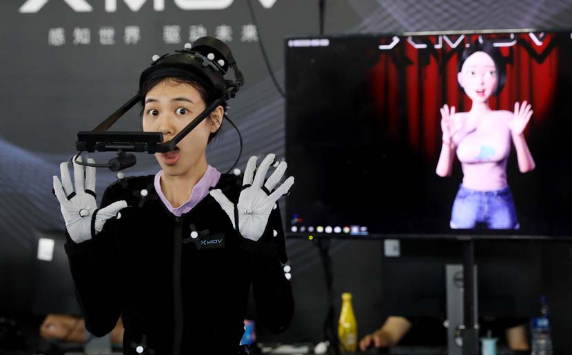 A staff member demonstrates a gesture-capturing system during the 2019 Consumer Electronics Show Asia in Shanghai, June 11, 2019. The three-day exhibition showcased the latest achievements in 5G technology, artificial intelligence, augmented and virtual reality, and vehicle technology. Fang Zhe/Xinhua