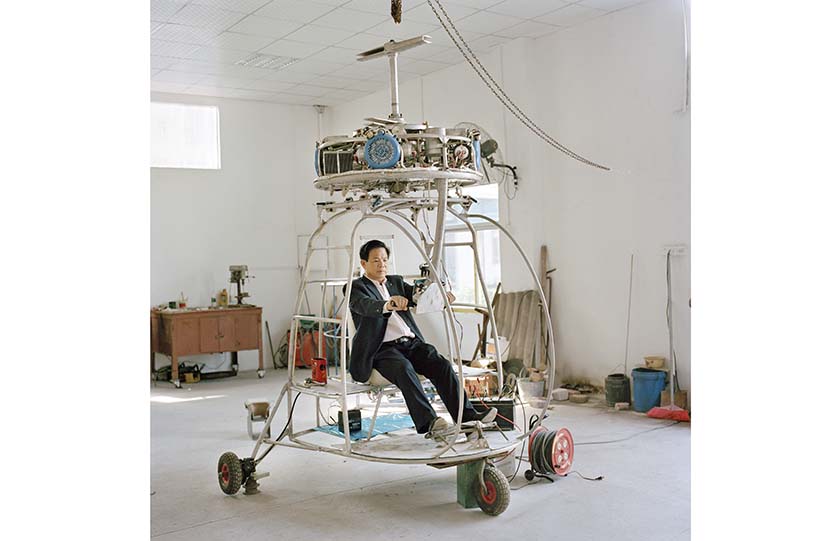 Zhang Dousan sits in the helicopter he built, “Dousan No. 5,” in Chaozhou, Guangdong province, 2015. From “Aeronautics in the Backyard”