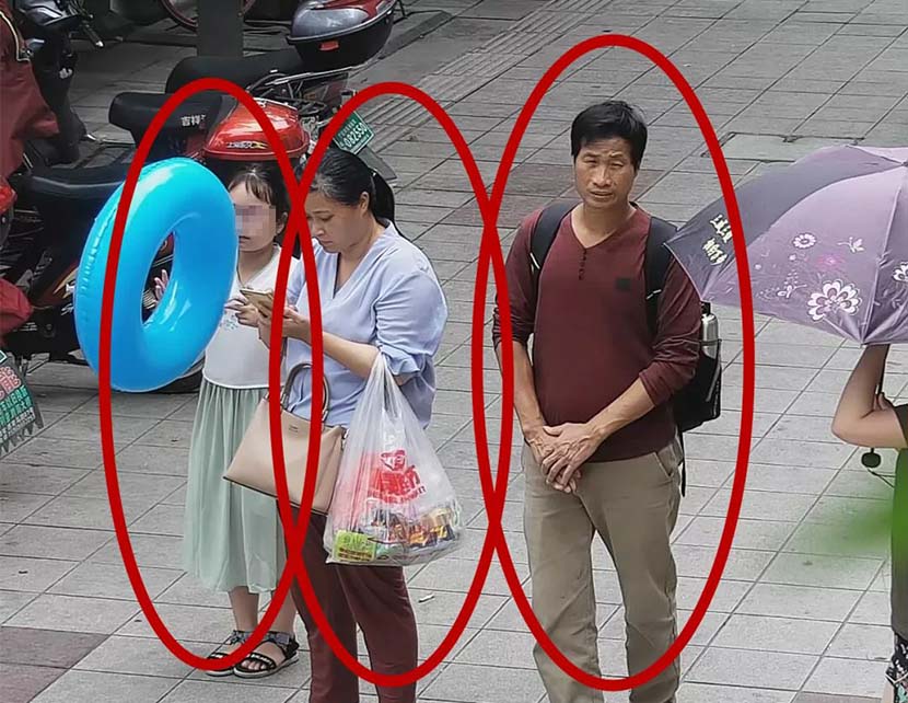 A screenshot taken from surveillance footage shows Zhang Zixin in front of a hotel along with the two suspected kidnappers in Xiangshan County, Ningbo, Zhejiang province, July 7, 2019. From The Paper