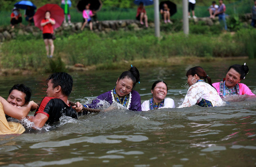 Local residents participate in a tug-of-war contest held in a river during the traditional Naoyu Festival in Liuzhou, Guangxi Zhuang Autonomous Region, July 18, 2019. Long Tao/IC