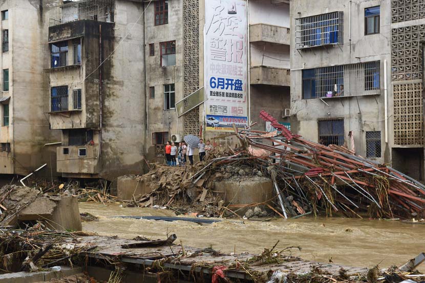 Villagers observe scattered debris caused by flooding in Shunchang County, Fujian province, July 9, 2019. Huang Zhimin/VCG