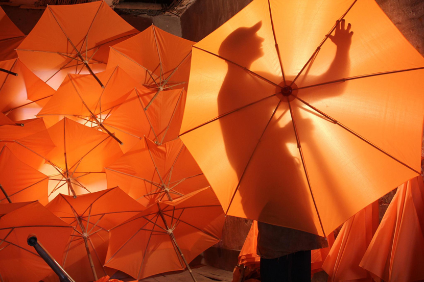 A worker makes oil-paper umbrellas at Zheng Guomin, a manufacturer of traditional oil-paper umbrellas in Jingxian County, Anhui province, July 22, 2019. Liu Hao/CNS/VCG
