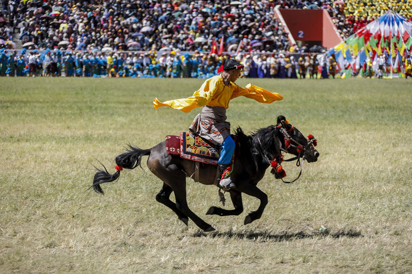 A man on horseback performs in the opening ceremony of Qinghai’s annual Yushu Horse Racing Festival in Yushu Tibetan Autonomous Prefecture, Qinghai province, July 25, 2019. Han Jiajun/VCG