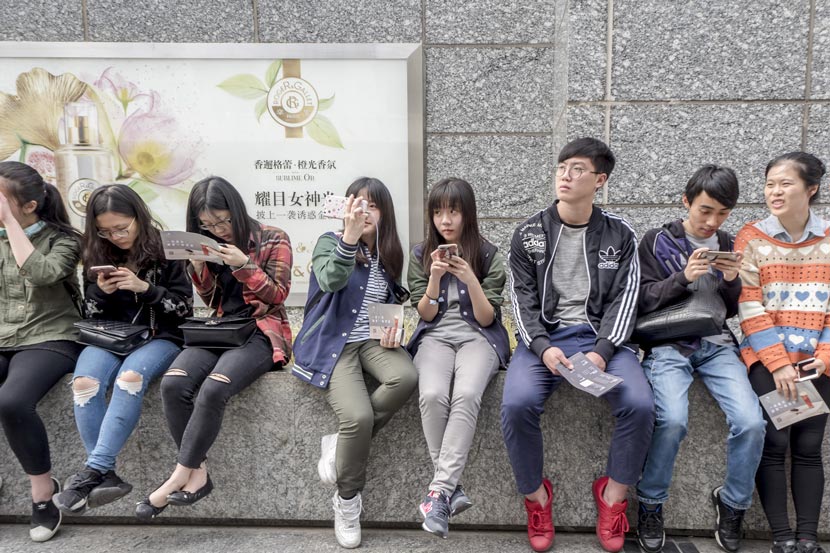 Young people wait in line to buy milk tea at a Heytea branch in Shanghai, April 21, 2017. Wang Gang/IC