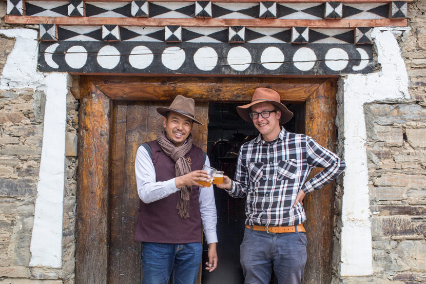 Norbu (left) and Maxim Nesazal pose for a photo at their craft beer brewery near Xinduqiao Town, Sichuan province, May 9, 2017. Zhou Pinglang/Sixth Tone