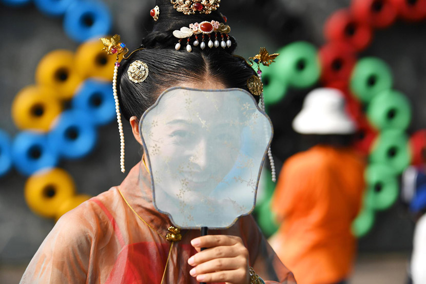 A woman dressed in “hanfu,” a type of traditional Chinese garment, poses for a photo in Shenzhen, Guangdong province, Sept. 14, 2019. Chen Wen/CNS/VCG