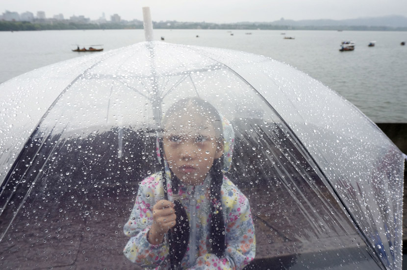 A girl holds an umbrella during a rainy day in Hangzhou, Zhejiang province, Aug. 29, 2019. Wu Huang/IC