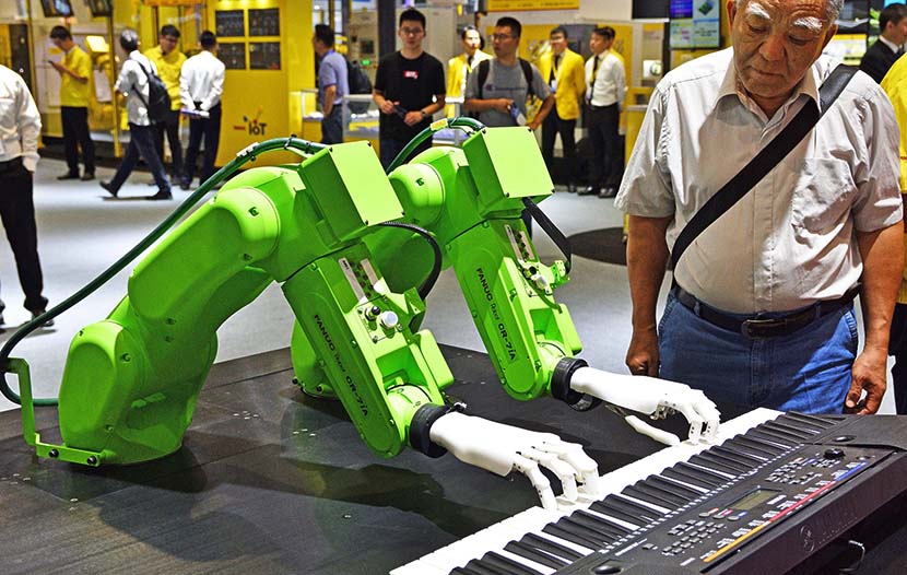 A robot plays the piano on opening day of the 21st China International Industry Fair in Shanghai, Sept. 17, 2019. VCG
