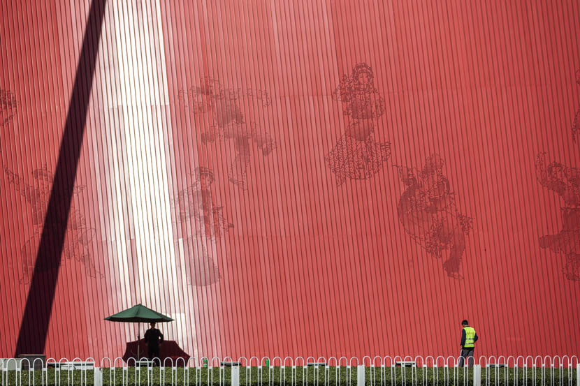 Ahead of the upcoming National Day holiday, a worker waters plants in front of a large installation at Tiananmen Square in Beijing, Sept. 24, 2019. Shen Qilai /Bloomberg via Getty Images/VCG