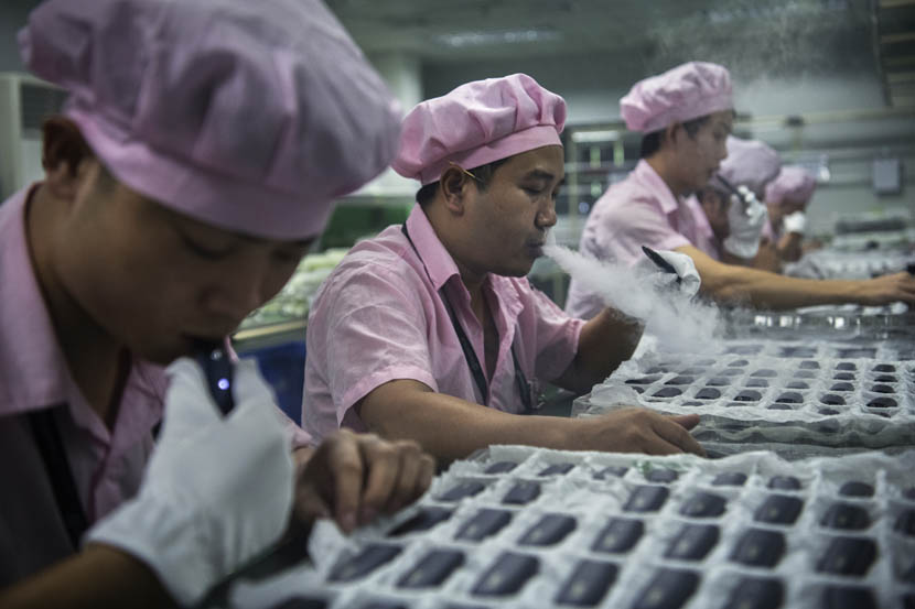 Factory workers test e-cigarettes on a production line at Kangertech, one of China’s leading manufacturers of vaping products, in Shenzhen, Guangdong province, Sept. 24, 2019. Kevin Frayer/Getty Images/VCG