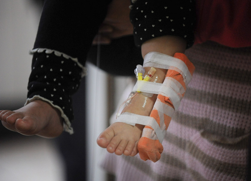 A child diagnosed with an HCV infection receives treatment at a hospital in Bozhou, Anhui province, Nov. 28, 2011. VCG