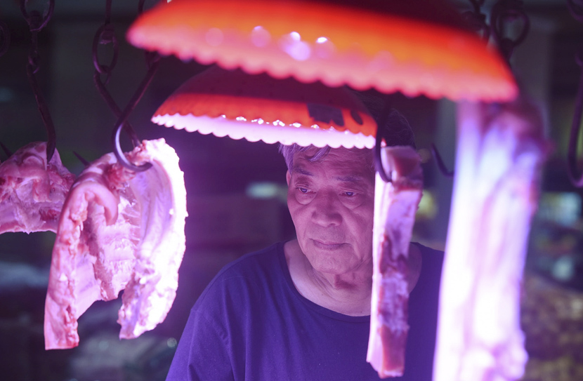 A customer purchases pork at an agricultural trade market in Hangzhou, Zhejiang province, Oct. 15, 2019. China’s consumer price index (CPI) rose 3% year-over-year in September, according to the data released by the National Bureau of Statistics this week. Long Wei/VCG