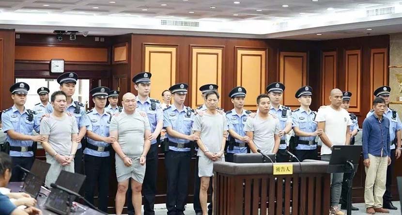 The six suspects stand trial for intentional homicide at the intermediate people’s court in Nanning, Guangxi Zhuang Autonomous Region, Oct. 17, 2019. From the court’s public WeChat account