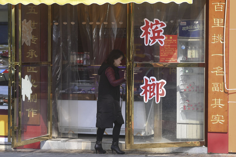An owner opens the door to her betel nut store in Changsha, Hunan province, March 11, 2019. Yang Huafeng/CNS/VCG