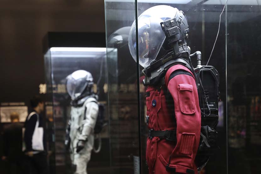 Visitors view costumes from 'The Wandering Earth' during the 22nd China Beijing International High-Tech Expo in Beijing, Oct. 24, 2019. IC