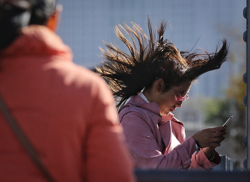 Wind blows through a woman’s hair in Harbin, Heilongjiang province, Oct. 31, 2019. Zhang Shu/IC
