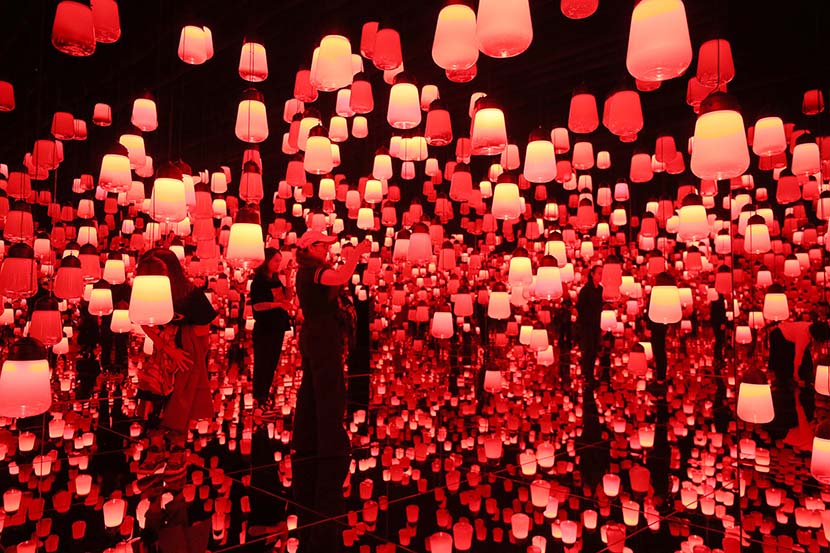 People visit the “TeamLab Borderless Shanghai” art event in Huangpu district, Shanghai, Nov. 7, 2019. VCG