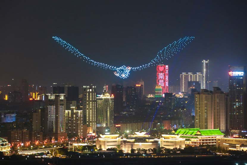 A fleet of 1,100 unmanned aerial vehicles flies in the formation of a bird above the Pavilion of Prince Teng to celebrate the launch of this year’s Poyang Lake International Bird Watching Week in Nanchang, Jiangxi province, Dec. 5, 2019. Ma Yue/VCG