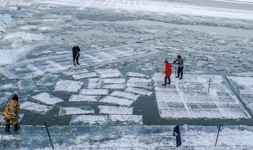 Workers cut ice at an ice mining site in Harbin, Heilongjiang province, Dec. 11, 2019.