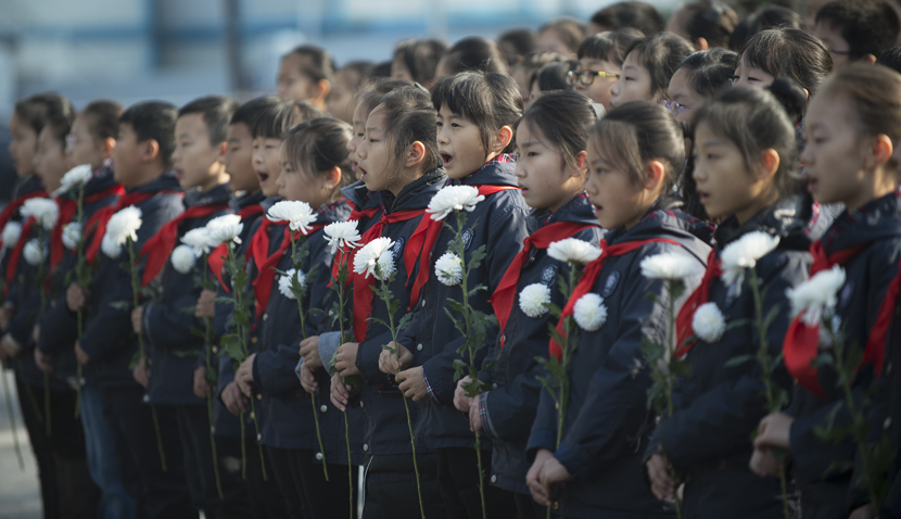 Children attend a remembrance event for the victims of the 1937 Nanjing Massacre at one of the mass burial sites in Nanjing, Jiangsu province, Dec. 13, 2019. Li Yuze/Xinhua