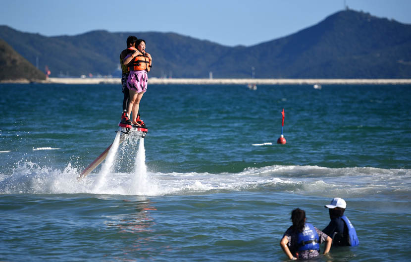 Tourists enjoy aquatic activities in Sanya, Hainan province, Dec. 21, 2019. Guo Cheng/Xinhua