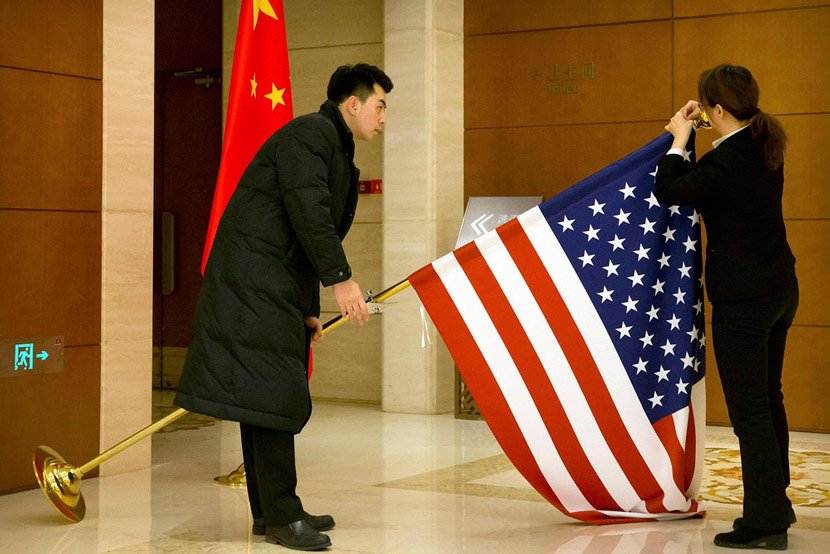 Chinese staff adjust a U.S. flag before trade talks commence at Diaoyutai State Guesthouse in Beijing, Feb. 14, 2019. Mark Schiefelbein/Pool/VCG