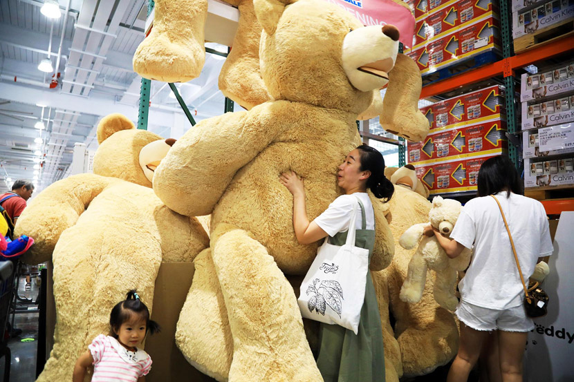 A woman holds a teddy bear at Costco’s first outlet store in the Chinese mainland in Shanghai, Aug. 29, 2019. Tang Yanjun/CNC/VCG
