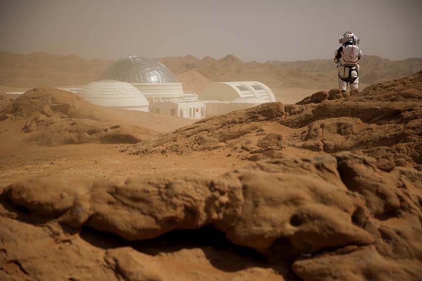 A staff member wearing a mock space suit poses at the C-Space Project Mars simulation base in the Gobi Desert near Jinchang, Gansu province, April 18, 2019. Thomas Peter/Reuters/VCG