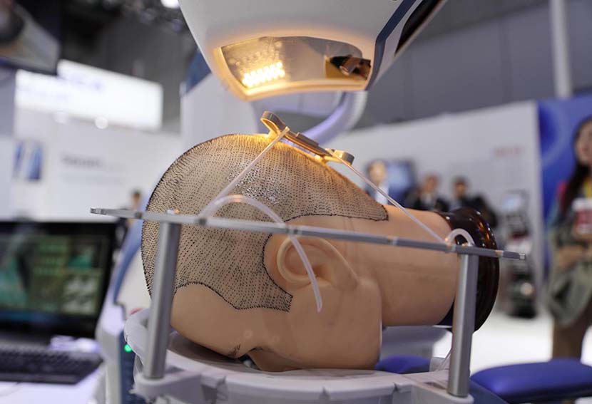 A robotic hair transplant machine is seen on day two of the 2nd China International Import Expo (CIIE) at the National Exhibition and Convention Center in Shanghai, Nov. 6, 2019. Zhang Hengwei/CNS/VCG