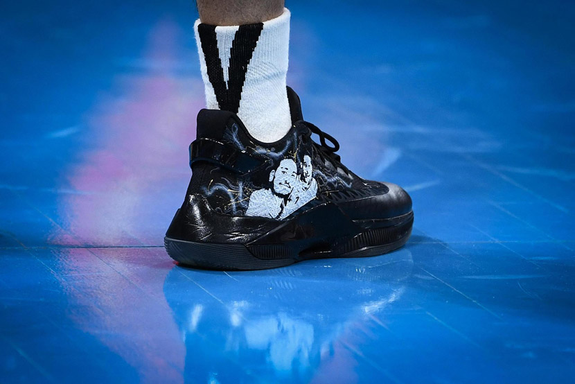 Basketball player Jeremy Lin wears customized sneakers printed with a photo of him and his friend Godfrey Gao during a Chinese Basketball Association game in Beijing, Nov. 28, 2019. Gao died this week at 35 after he collapsed during filming of the action reality show “Chase Me.” Cui Nan/CNS/VCG