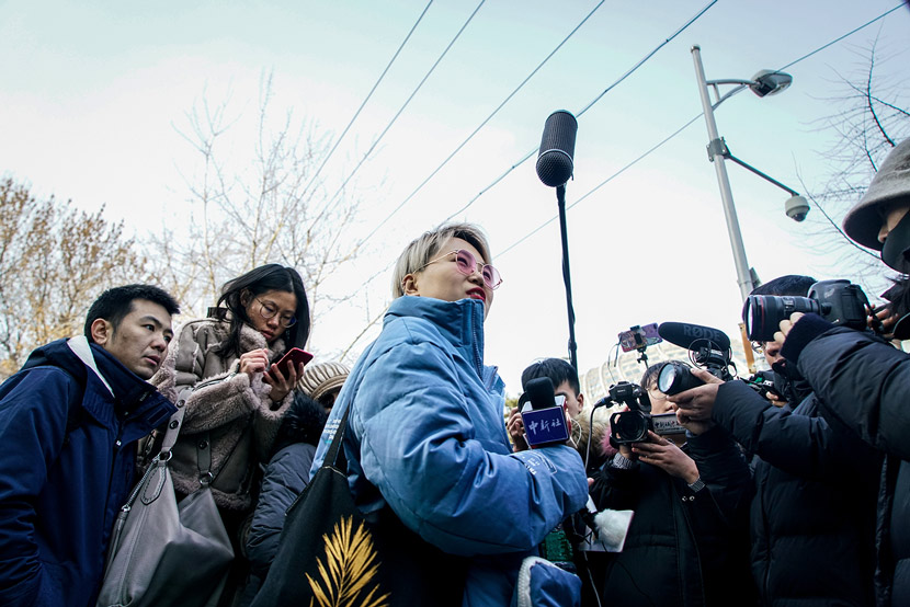 Xu Zaozao (center), the plaintiff of a case on the right to freeze eggs as a single woman, does an interview in front of the court after the first hearing in Chaoyang District in Beijing, Dec. 23, 2019. Cai Xingzhuo/JIEMIAN