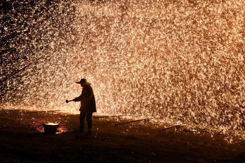 A man performs “datiehua,” or “striking iron flowers,” as part of the New Year celebrations in Zhangjiakou, Hebei province, Jan. 1, 2020. Zhang Zifa/CNS
