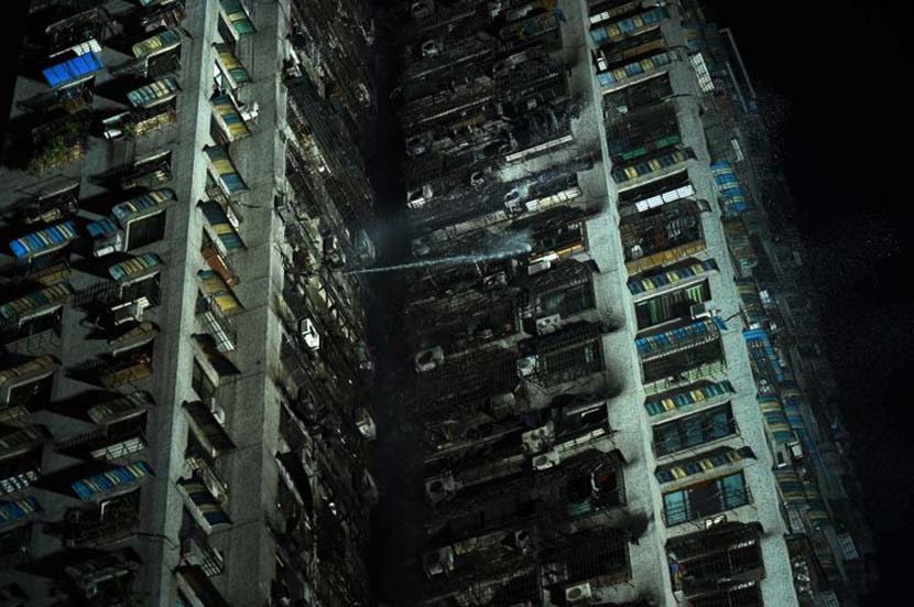 Firefighters douse a fire in a 30-story residential building in Chongqing, Jan. 2, 2020. Chen Chao/CNS