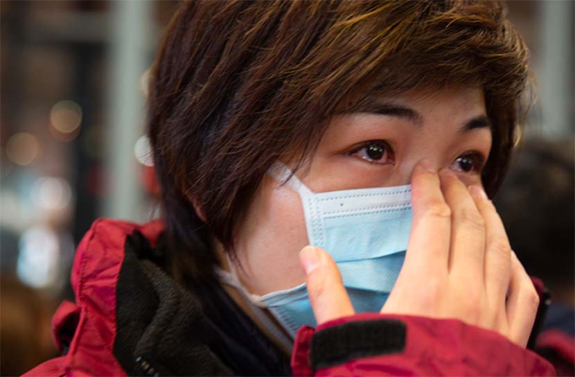 A nurse on her way to Wuhan to help with the emergency medical relief efforts bids farewell to her son on Lunar New Year’s Eve at Shanghai Hongqiao International Airport, Feb. 24, 2020. From The Paper