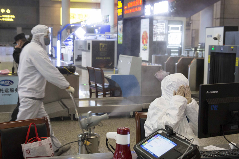 A worker sprays disinfectant in the departures hall of Shanghai Hongqiao Railway Station in Shanghai, Feb. 1, 2020. Yi Chuan for Sixth Tone