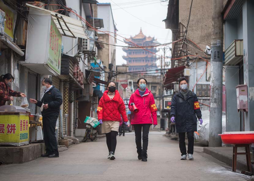 Community workers publicize anti-epidemic measures near Yellow Crane Tower in Wuhan, Hubei province, Feb. 7, 2020. Xinhua