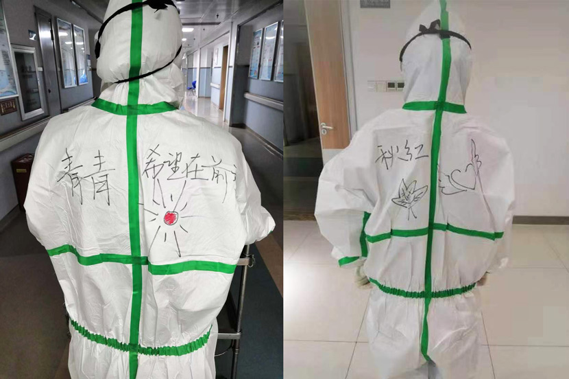 Medical workers show off the encouraging words written on the protective suits supplied with the help of Guo’s team in Xiaogan, Hubei province, 2020. Courtesy of Guo Fei’s volunteer group