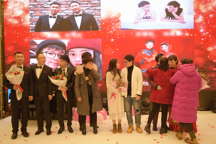 Participants in a group wedding ceremony for same-sex couples stand onstage in Wuhan, Hubei province, Jan. 4, 2020. Courtesy of PFLAG