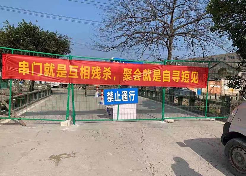 A banner bearing the slogan, “by visiting others’ homes, you’re murdering each other; by partying, you’re committing suicide” hangs outside a rural residential compound in Wenzhou, February 2020. Courtesy of Duoduo