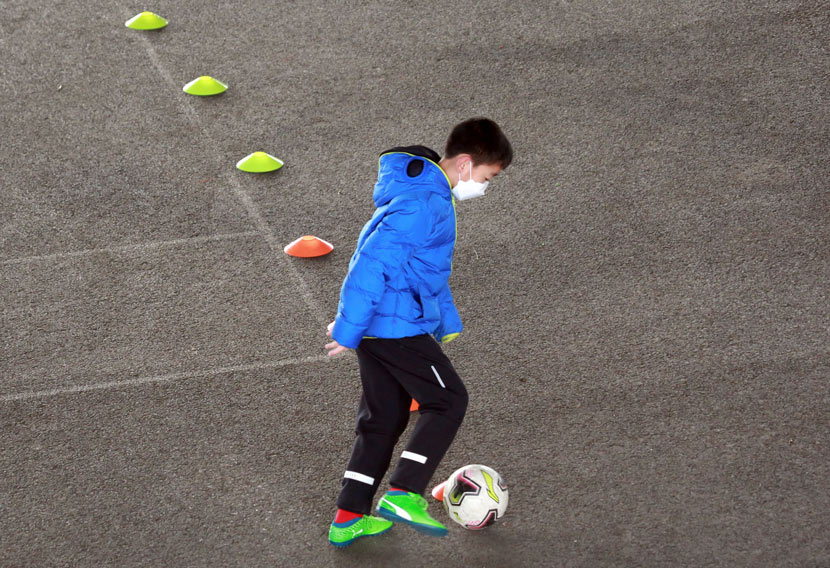 A boy practices his soccer skills in Shenyang, Liaoning province, Feb. 12, 2020. Huang Jinkun/IC