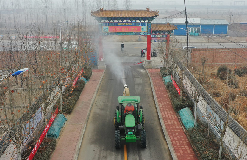 Disinfectant is sprayed from a tractor in a neighborhood of Luanzhou, Hebei province, Feb. 14, 2020. Yu Aishuang via Xinhua